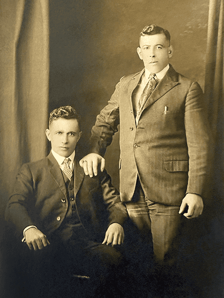 The rounded “club collar” and the high cut vest are typical of 1915-1920 Edwardian men’s fashion.<br />
The close postures of these two men suggest something more than mere friendship.